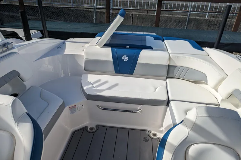 Slide: The Image of 2023 Chaparral 23 Surf boat interior with white and blue seating. - 11