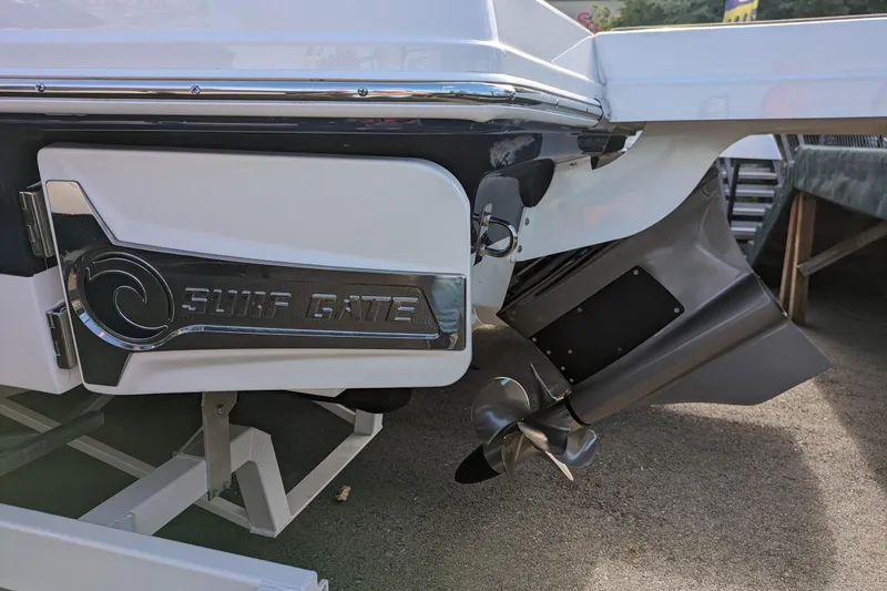 Slide: The Image of 2023 Chaparral 23 Surf boat with Surf Gate feature and propeller detail. - 17