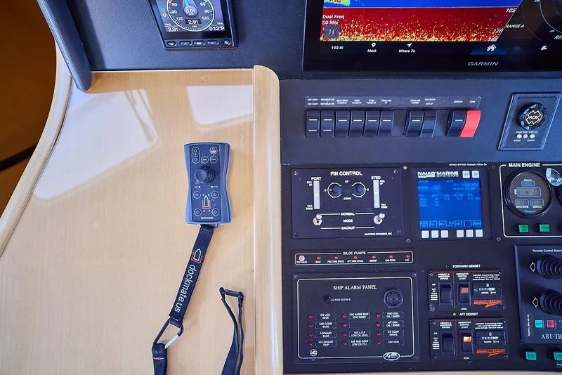 Slide: The Image of Control panel of a 2000 Northern Marine 75 yacht with navigation and engine controls. - 11