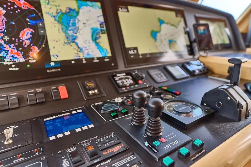Slide: The Image of Control panel of a 2000 Northern Marine 75 yacht with navigation screens and controls. - 13
