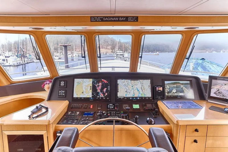 Slide: The Image of Cockpit of 2000 Northern Marine 75 yacht with navigation screens and marina view. - 18