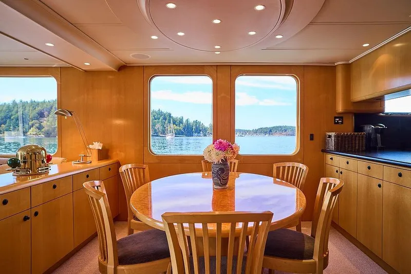 Slide: The Image of Luxurious dining area on a 2000 Northern Marine 75 yacht with scenic water views. - 23