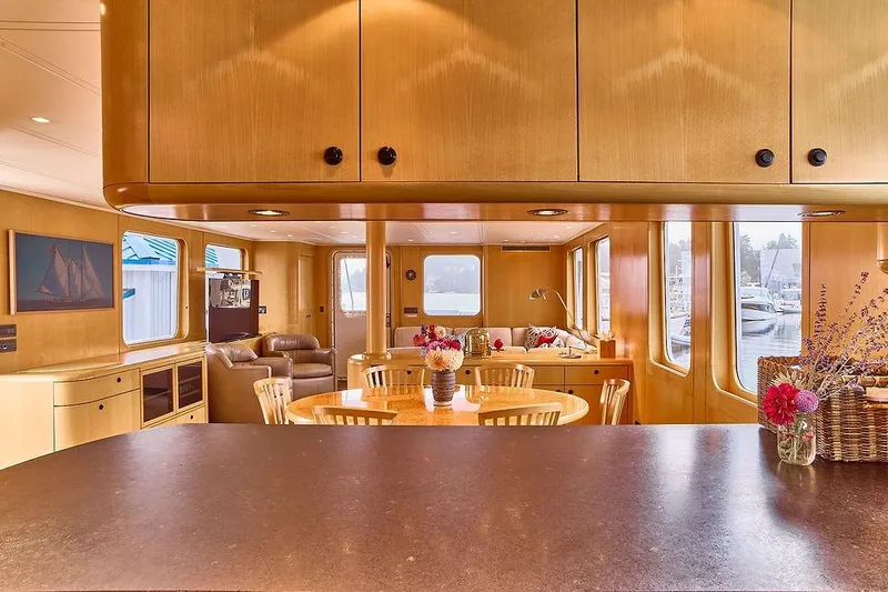 Slide: The Image of Luxurious interior of 2000 Northern Marine 75 yacht with elegant wood finishes and floral decor. - 24