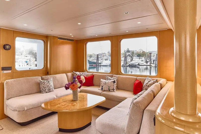 Slide: The Image of Luxurious interior of 2000 Northern Marine 75 yacht with plush seating and marina view. - 25