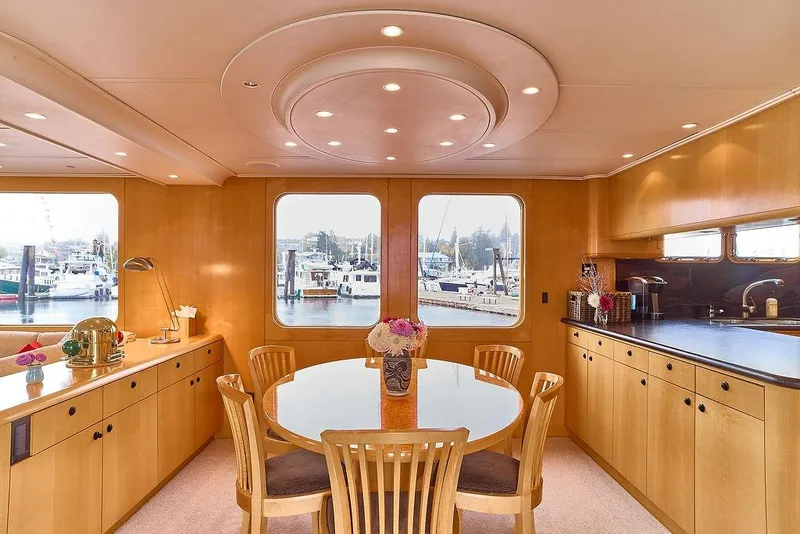 Slide: The Image of Luxurious dining area on a 2000 Northern Marine 75 yacht with elegant wood finishes. - 31