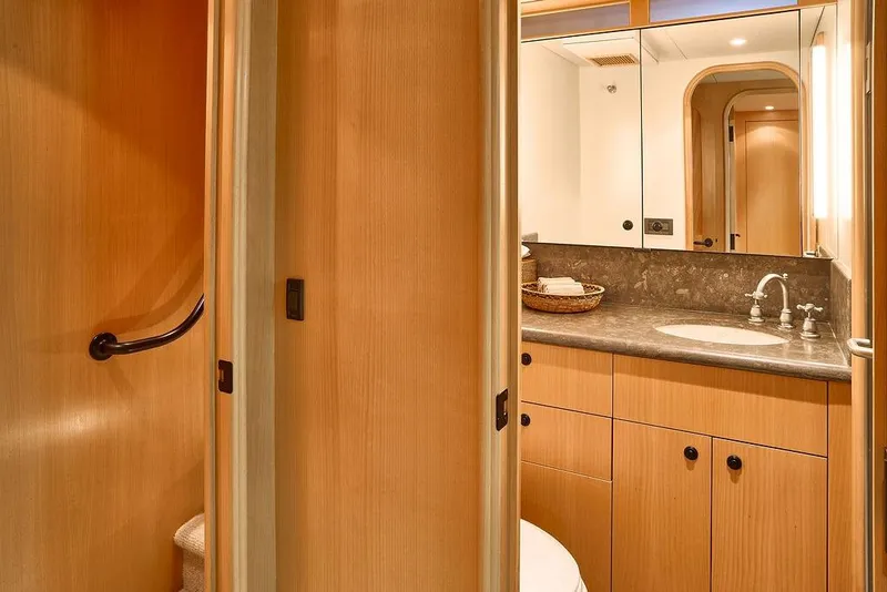 Slide: The Image of Luxurious bathroom interior on a 2000 Northern Marine 75 yacht, featuring wood cabinetry and modern fixtures. - 36