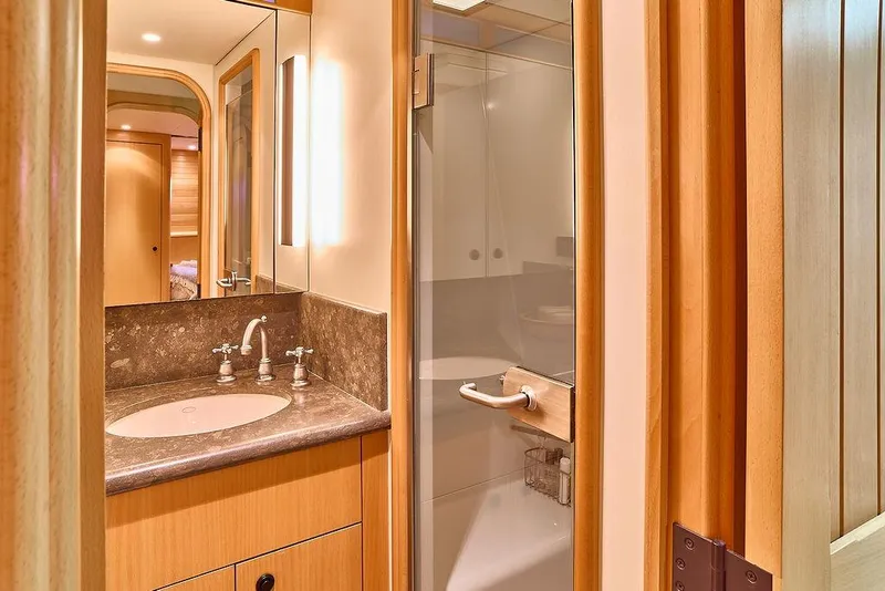 Slide: The Image of Luxurious bathroom interior on 2000 Northern Marine 75 yacht, featuring elegant wood and marble finishes. - 37
