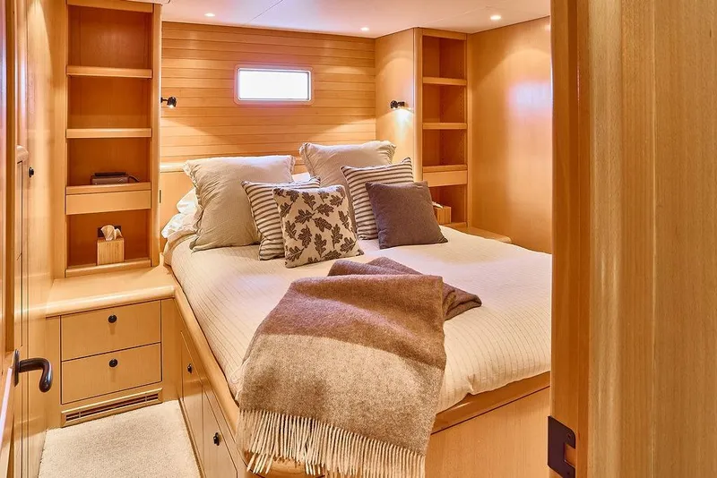 Slide: The Image of Luxurious cabin interior of 2000 Northern Marine 75 yacht with cozy bed and wooden shelves. - 38