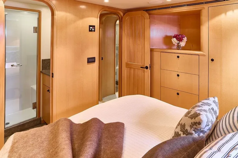 Slide: The Image of Luxurious bedroom interior of 2000 Northern Marine 75 yacht with wooden cabinetry and ensuite bathroom. - 39