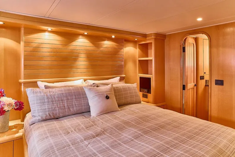 Slide: The Image of Luxurious bedroom interior of 2000 Northern Marine 75 yacht with cozy bedding and wooden accents. - 44