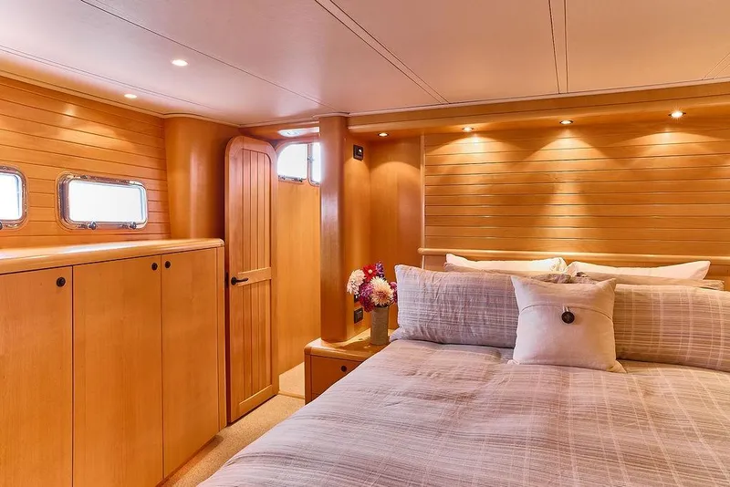 Slide: The Image of Luxurious cabin interior of 2000 Northern Marine 75 yacht with wood paneling and cozy bedding. - 45