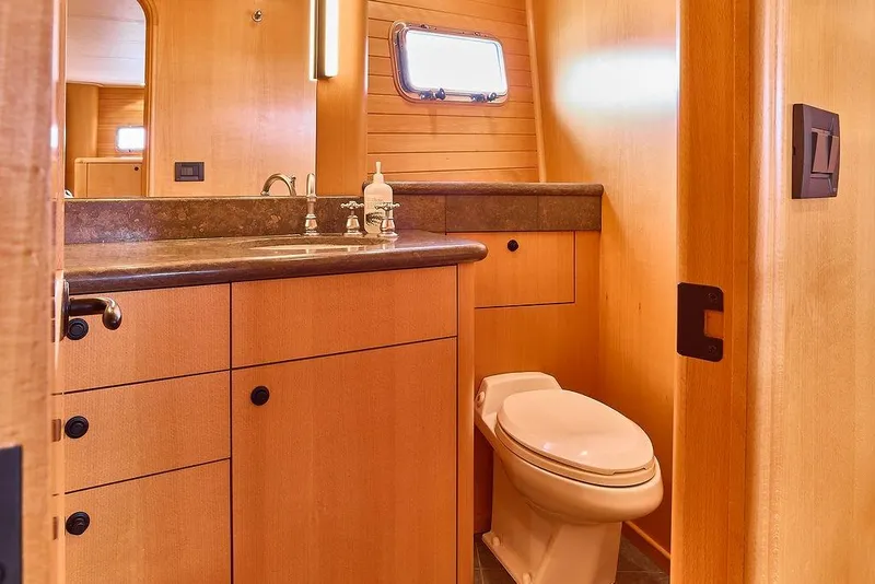 Slide: The Image of Luxurious bathroom in 2000 Northern Marine 75 yacht with wooden cabinetry and modern fixtures. - 48