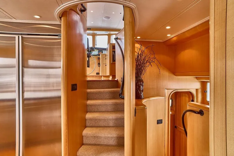 Slide: The Image of Luxurious interior of 2000 Northern Marine 75 yacht with elegant wooden staircase. - 52