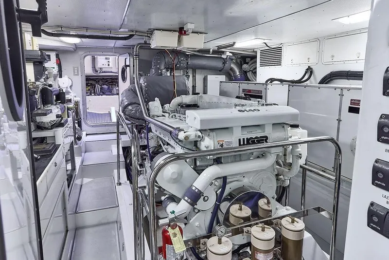 Slide: The Image of Engine room of 2000 Northern Marine 75 yacht, featuring Lugger engine and control panels. - 57