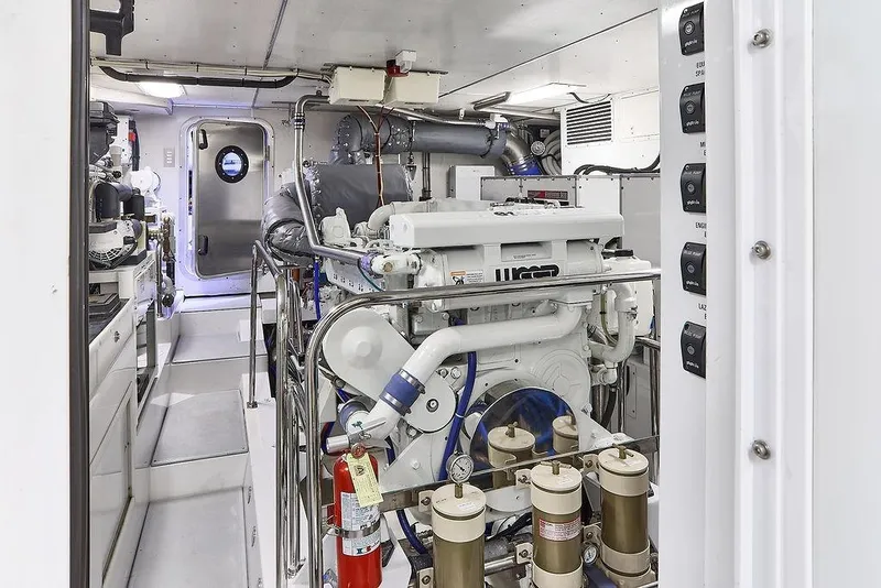 Slide: The Image of Engine room of a 2000 Northern Marine 75 yacht, featuring advanced machinery and controls. - 58