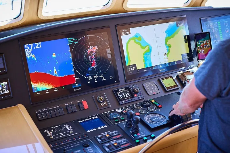 Slide: The Image of Control panel of a 2000 Northern Marine 75 yacht with navigation screens and controls. - 6