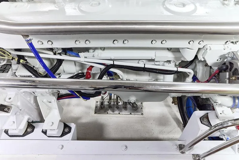 Slide: The Image of Engine compartment of a 2000 Northern Marine 75 yacht, featuring detailed mechanical components. - 61