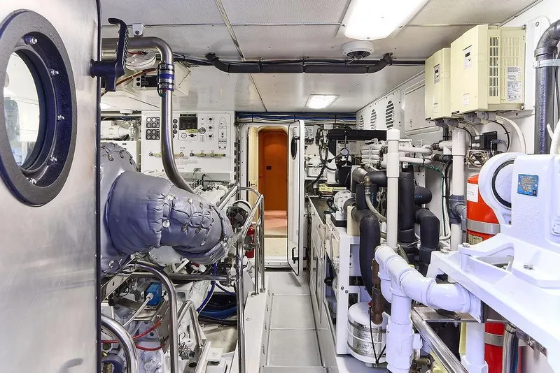 Slide: The Image of Engine room of a 2000 Northern Marine 75 yacht, showcasing machinery and equipment. - 63