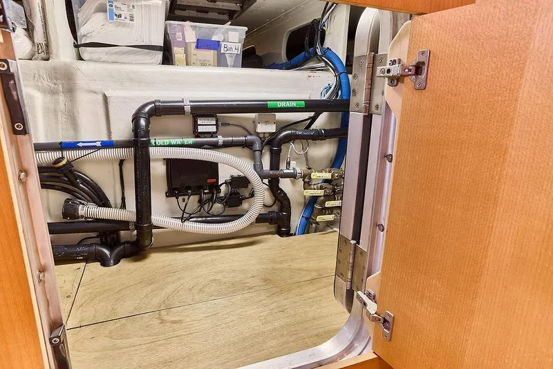 Slide: The Image of Engine room of 2000 Northern Marine 75 yacht, showcasing plumbing and storage. - 65