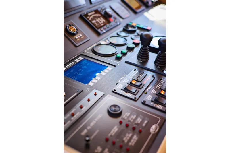 Slide: The Image of Control panel of a 2000 Northern Marine 75 yacht with gauges and joysticks. - 7