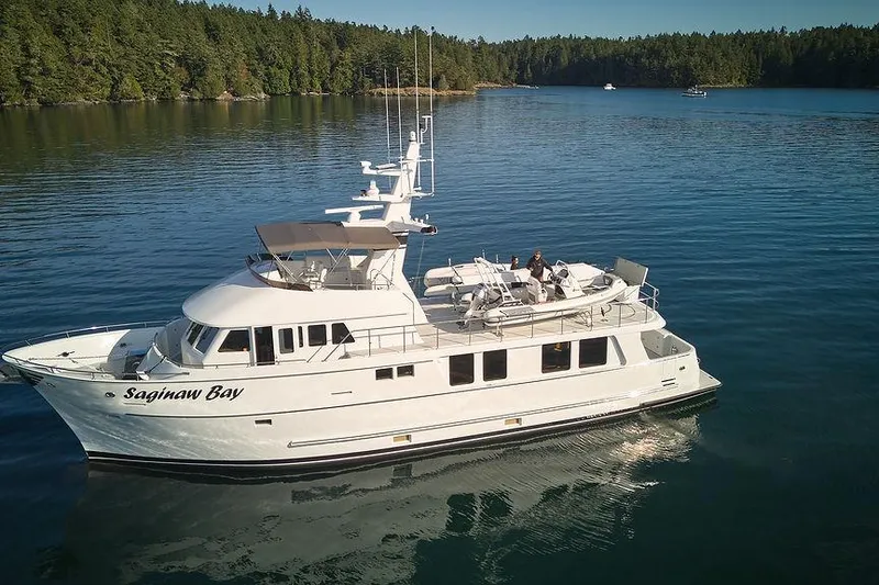 Slide: The Image of Northern Marine 75 yacht from 2000, named "Saginaw Bay," cruising on a serene lake. - 71