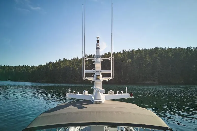 Slide: The Image of Northern Marine 75 yacht, 2000 model, cruising on calm waters with forested shoreline. - 76