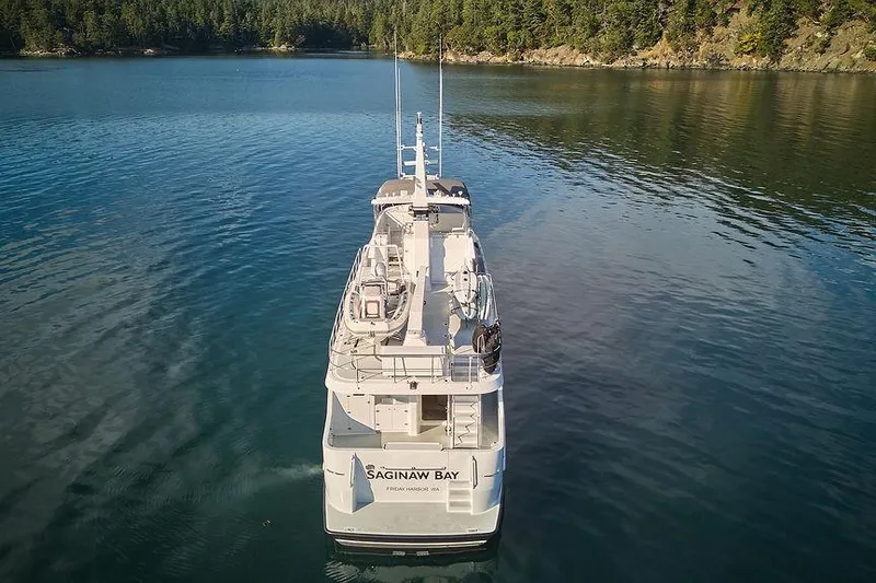 Slide: The Image of Northern Marine 75 yacht from 2000 on calm water, surrounded by forested shoreline. - 81