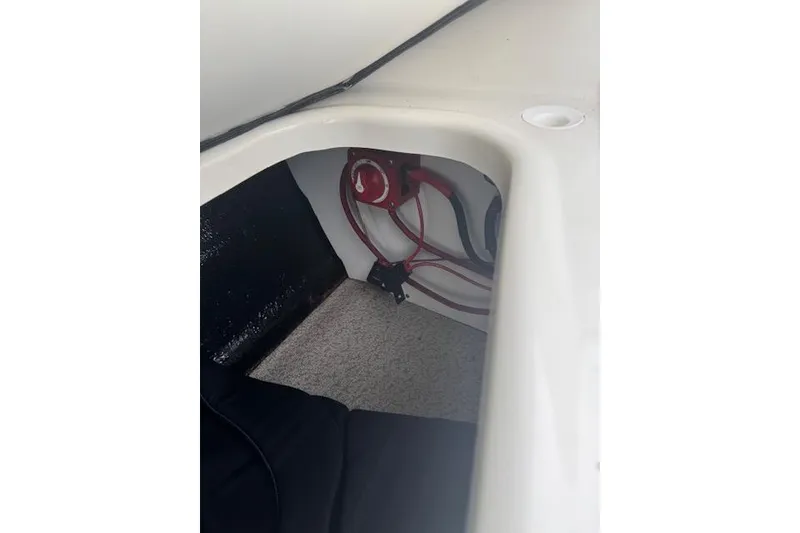 Slide: The Image of 2023 Stingray 182 SC boat interior wiring and battery compartment. - 15