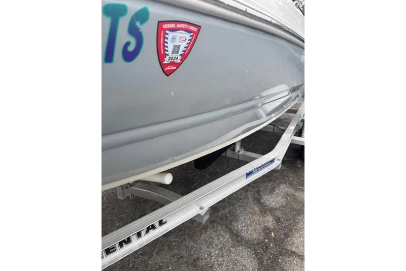 Slide: The Image of 2023 Stingray 182 SC boat on trailer with safety check sticker. - 19