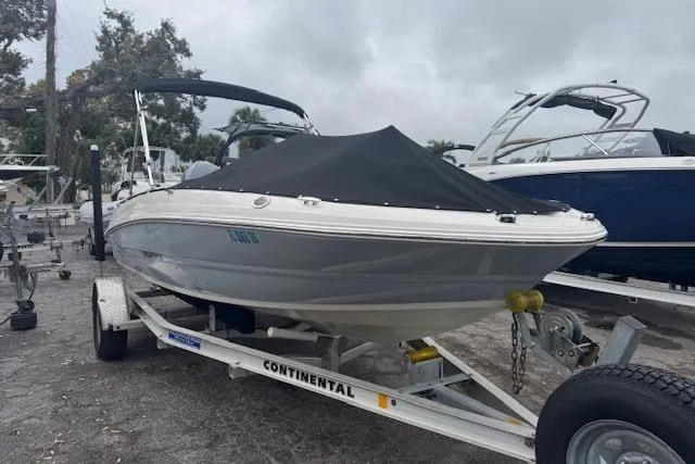 The Image of 2023 Stingray 182 SC boat on trailer, covered, parked outdoors. - 8