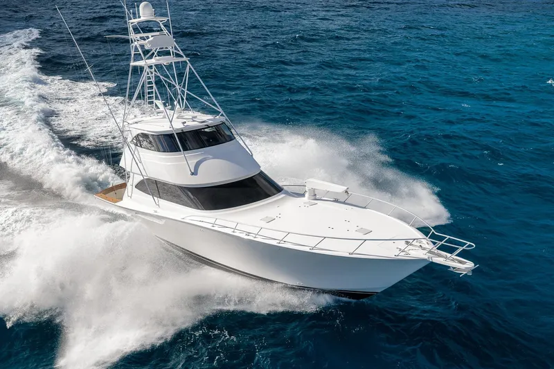 The Image of 2012 Viking 70 Enclosed Bridge yacht cruising on open ocean waters. - 0