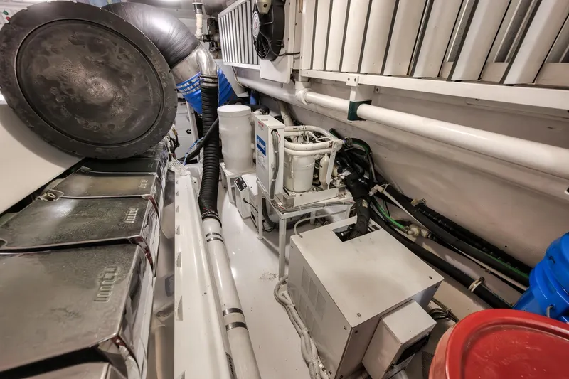 Slide: The Image of Engine room of 2012 Viking 70 Enclosed Bridge yacht, showcasing mechanical components and systems. - 100