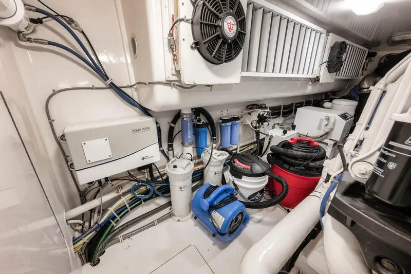 Slide: The Image of Engine room of 2012 Viking 70 Enclosed Bridge yacht with equipment and wiring. - 101
