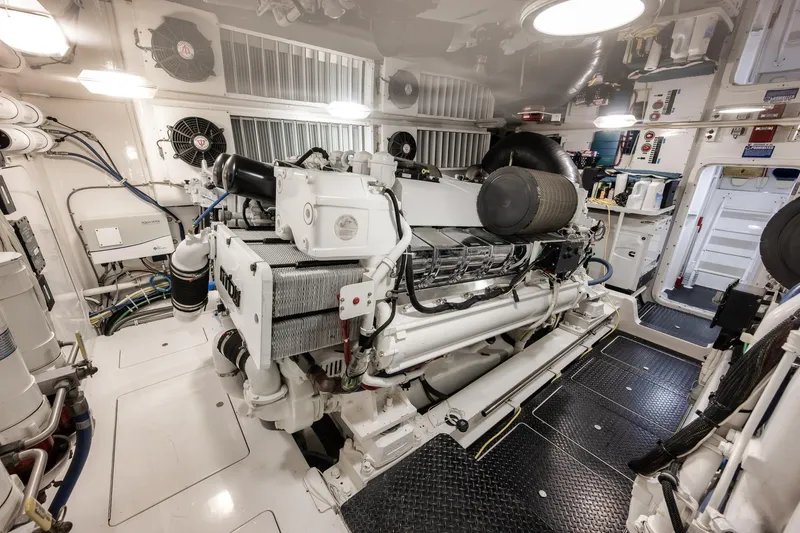 Slide: The Image of Engine room of 2012 Viking 70 Enclosed Bridge yacht, showcasing machinery and equipment. - 103