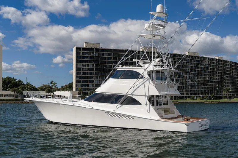 Slide: The Image of 2012 Viking 70 Enclosed Bridge yacht on water, with cityscape background. - 108