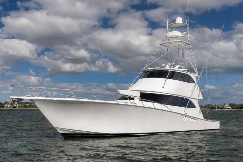 Slide: The Image of 2012 Viking 70 Enclosed Bridge yacht on water under cloudy sky. - 111