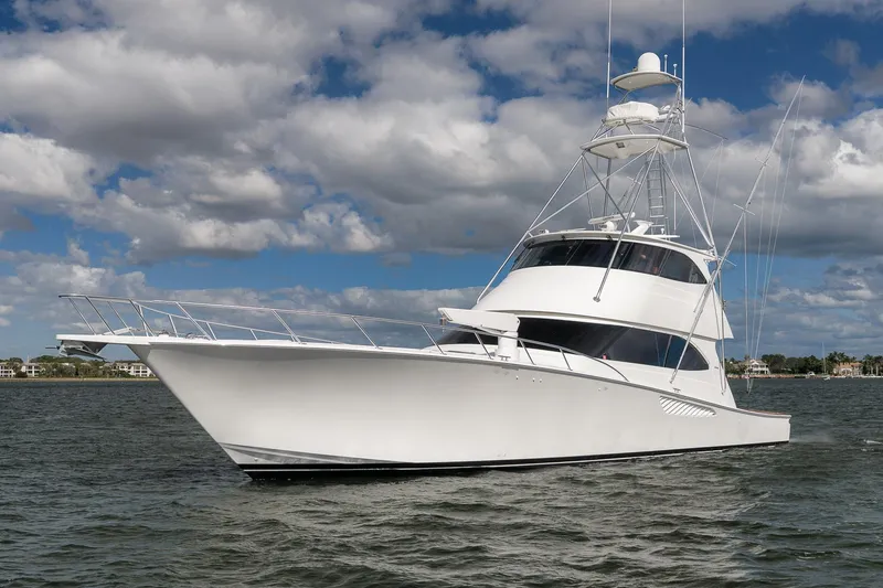 Slide: The Image of Luxury 2012 Viking 70 Enclosed Bridge yacht on open water under cloudy sky. - 112