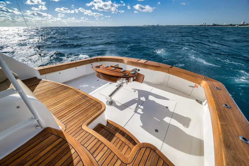 Slide: The Image of Luxurious 2012 Viking 70 Enclosed Bridge yacht with teak deck on open sea. - 16