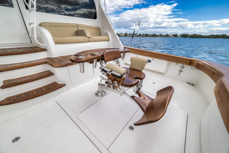 Slide: The Image of Luxurious 2012 Viking 70 Enclosed Bridge yacht deck with fishing chair and scenic water view. - 19