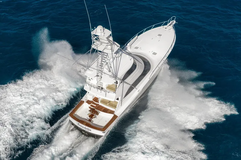 Slide: The Image of 2012 Viking 70 Enclosed Bridge yacht cruising on open ocean waters. - 2