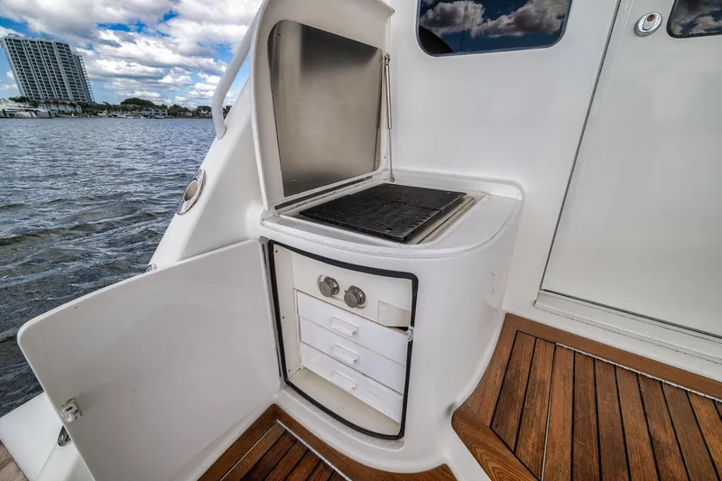 Slide: The Image of Outdoor grill and storage on 2012 Viking 70 Enclosed Bridge yacht deck. - 28