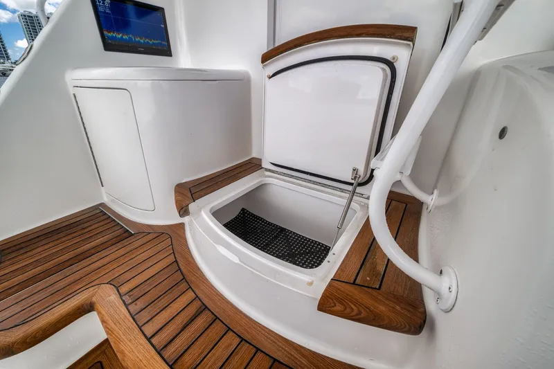 Slide: The Image of 2012 Viking 70 Enclosed Bridge yacht interior with wood flooring and storage compartment. - 29