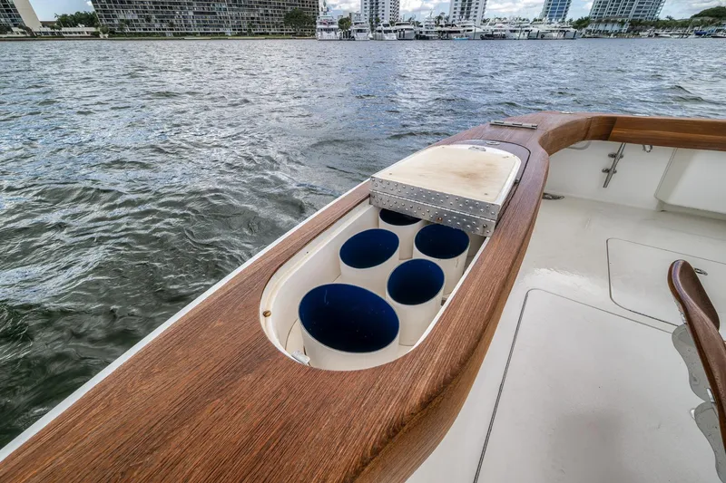 Slide: The Image of 2012 Viking 70 Enclosed Bridge yacht deck with rod holders and cutting board. - 33