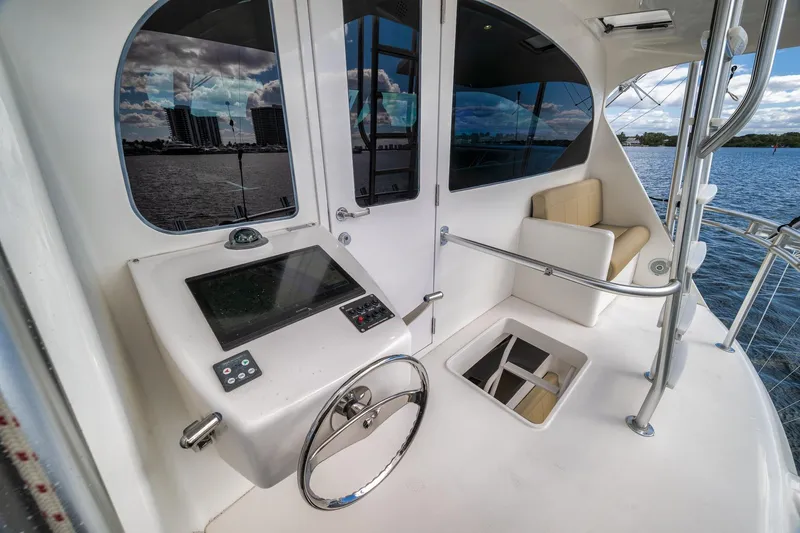 Slide: The Image of 2012 Viking 70 Enclosed Bridge yacht helm with modern controls and waterfront view. - 44