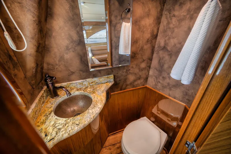 Slide: The Image of Luxurious bathroom in 2012 Viking 70 Enclosed Bridge yacht with granite countertop and elegant fixtures. - 49