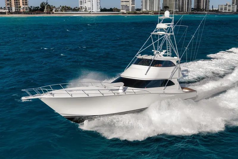 Slide: The Image of 2012 Viking 70 Enclosed Bridge yacht cruising on blue ocean waters. - 5