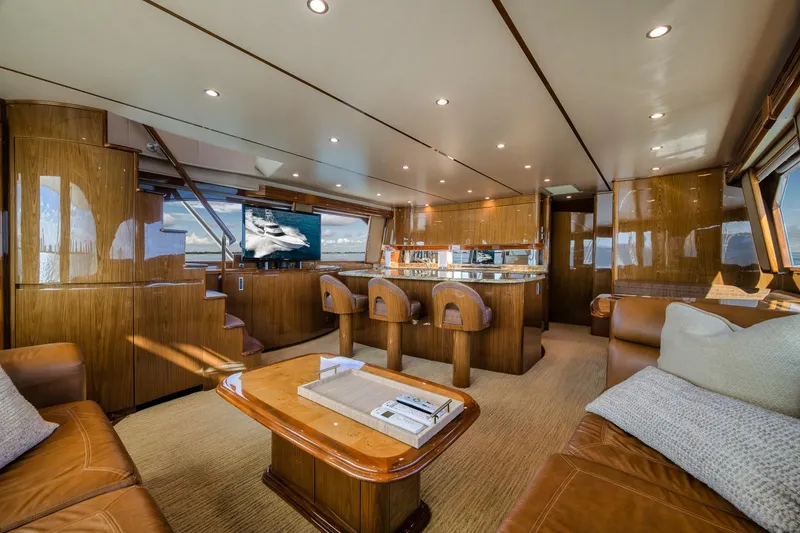 Slide: The Image of Luxurious interior of 2012 Viking 70 Enclosed Bridge yacht with elegant wood finishes and seating. - 52