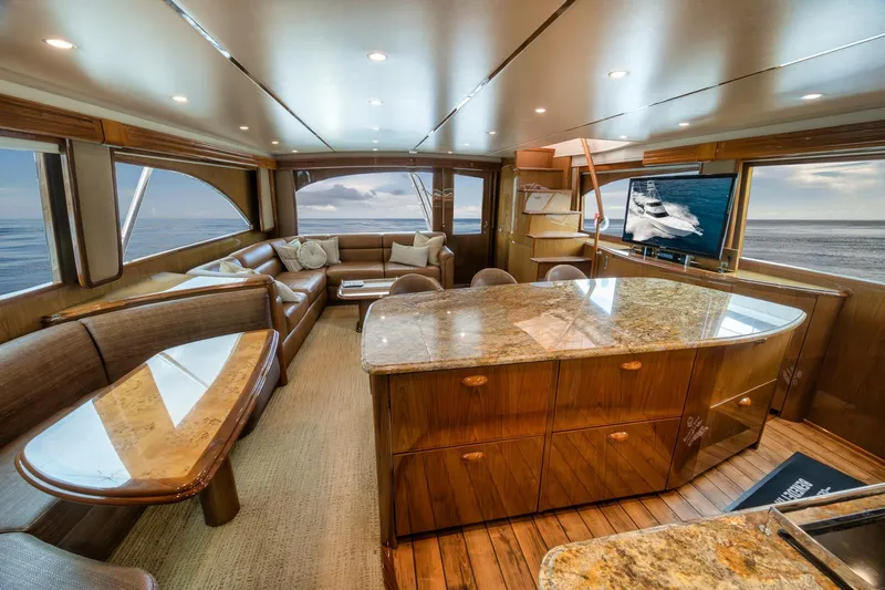 Slide: The Image of Luxurious interior of 2012 Viking 70 Enclosed Bridge yacht with elegant seating and ocean view. - 59