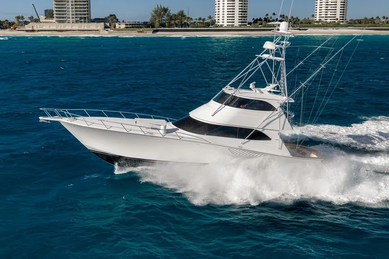 Slide: The Image of 2012 Viking 70 Enclosed Bridge yacht cruising on blue ocean near coastline. - 6