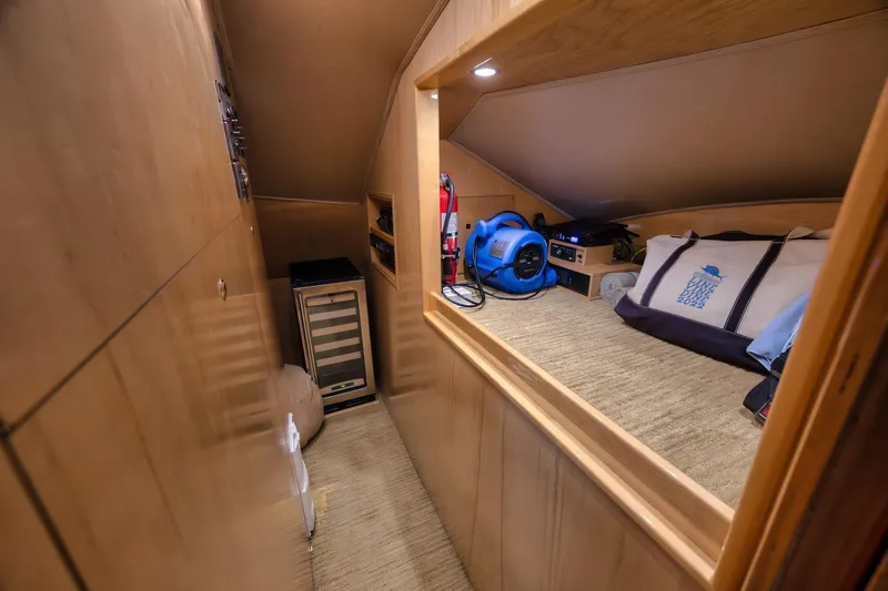 Slide: The Image of 2012 Viking 70 Enclosed Bridge interior with storage, equipment, and a cozy sleeping area. - 62